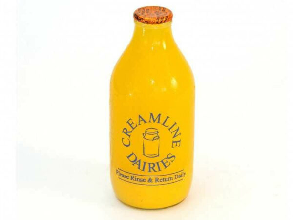 One pint of orange juice in a glass bottle