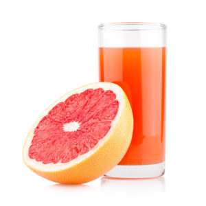 A grapefruit and a glass of grapefruit juice