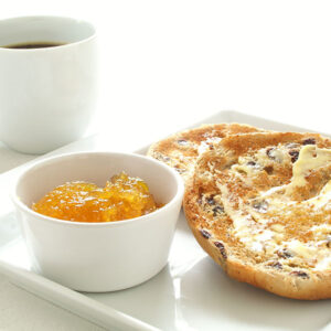 Two tea cakes with butter and marmelade