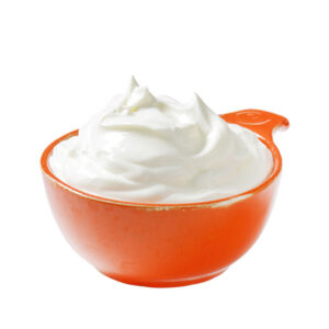 An orange ceramic bowl with white creme fraiche